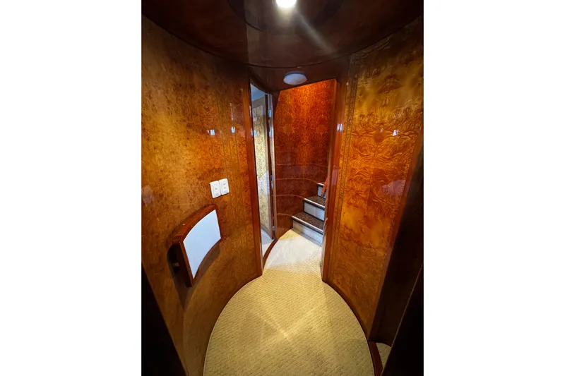 Atlantis Yacht Photos Pics Luxurious wood-paneled hallway inside 1996 Hershine Benship 87 yacht, featuring elegant curved design.