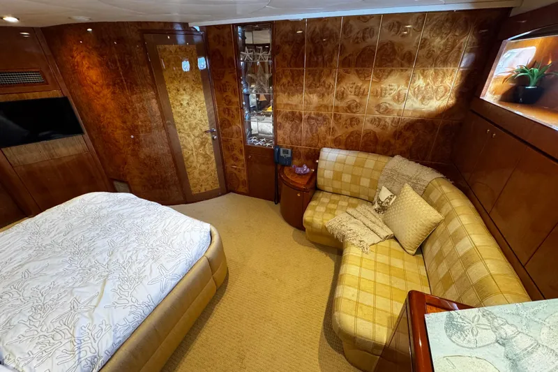Atlantis Yacht Photos Pics Luxurious 1996 Hershine Benship 87 yacht cabin with elegant wood paneling and cozy seating area.