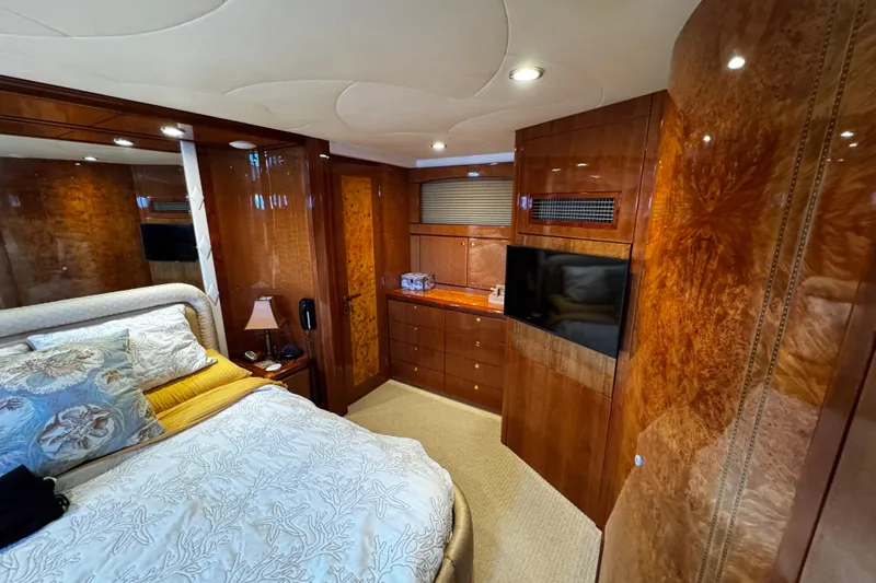 Atlantis Yacht Photos Pics Luxurious cabin interior of 1996 Hershine Benship 87 yacht with wood paneling and elegant bedding.