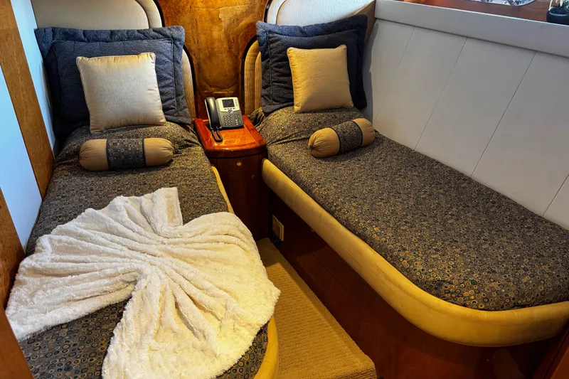 Atlantis Yacht Photos Pics Luxurious twin cabin on 1996 Hershine Benship 87 yacht with elegant bedding and decor.