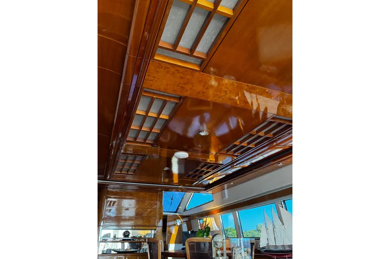 Atlantis Yacht Photos Pics Luxurious wooden interior of 1996 Hershine Benship 87 yacht with elegant ceiling design.