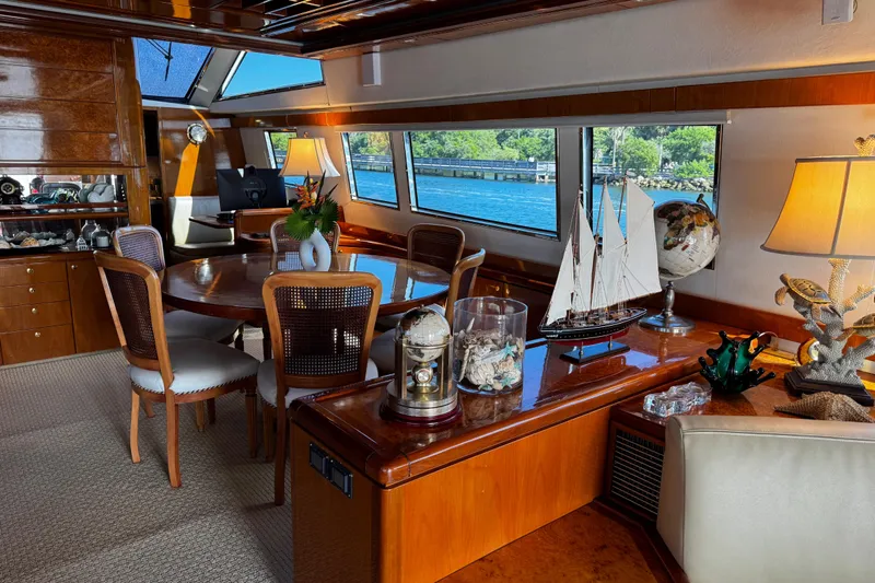 Atlantis Yacht Photos Pics Luxurious 1996 Hershine Benship 87 yacht interior with elegant dining area and nautical decor.