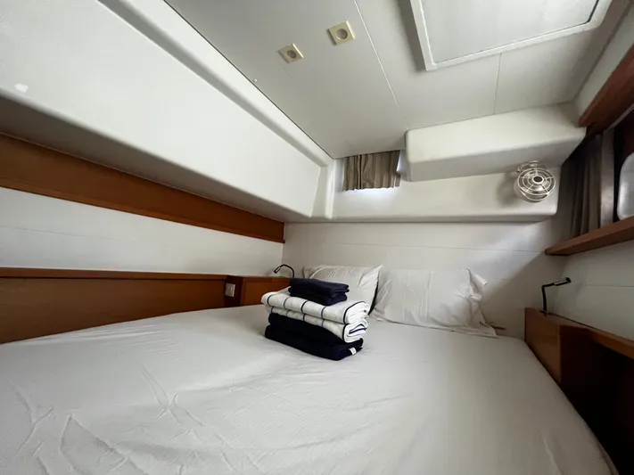 Cristal Yacht Photos Pics Cozy cabin interior of 2018 Lagoon 450 F catamaran with neatly arranged bedding.