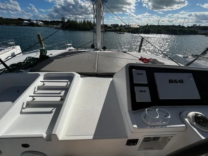 Cristal Yacht Photos Pics Lagoon 450 F catamaran helm with B&G navigation, docked by a scenic waterfront.