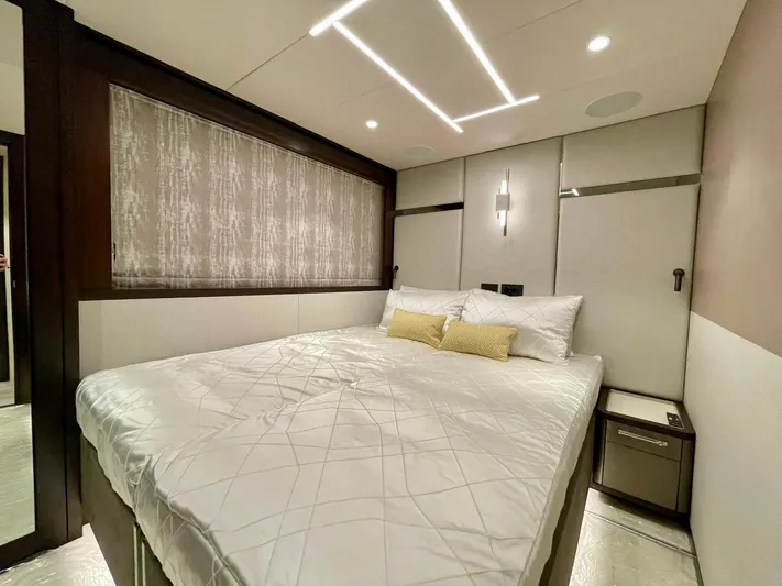 Yacht Photos Pics Luxurious bedroom interior of 2022 Sunseeker 88 Yacht with modern lighting and elegant bedding.
