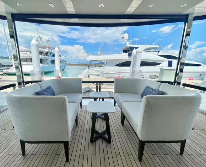  Yacht Photos Pics Luxurious Sunseeker 88 Yacht 2022 with elegant outdoor seating and marina view.
