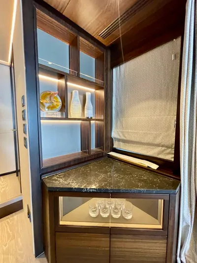  Yacht Photos Pics Luxurious interior of 2022 Sunseeker 88 Yacht with elegant shelving and decor.