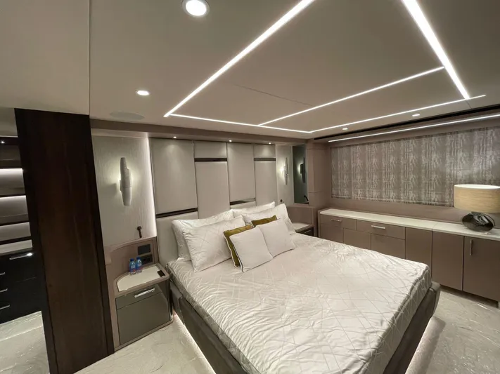  Yacht Photos Pics Luxurious bedroom interior of 2022 Sunseeker 88 Yacht with modern design and ambient lighting.
