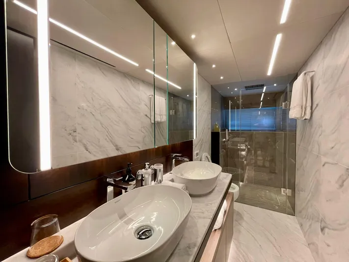  Yacht Photos Pics Luxurious bathroom in 2022 Sunseeker 88 Yacht with modern fixtures and marble design.
