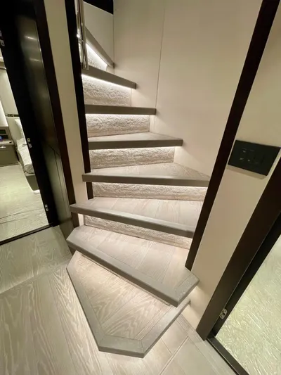  Yacht Photos Pics Staircase inside 2022 Sunseeker 88 Yacht, featuring modern design and ambient lighting.