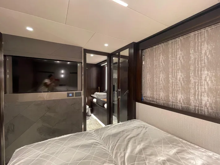  Yacht Photos Pics Luxurious bedroom interior of 2022 Sunseeker 88 Yacht with modern design and elegant furnishings.