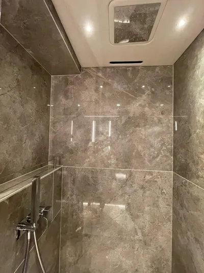  Yacht Photos Pics Luxurious marble bathroom in 2022 Sunseeker 88 Yacht, featuring modern fixtures and elegant lighting.