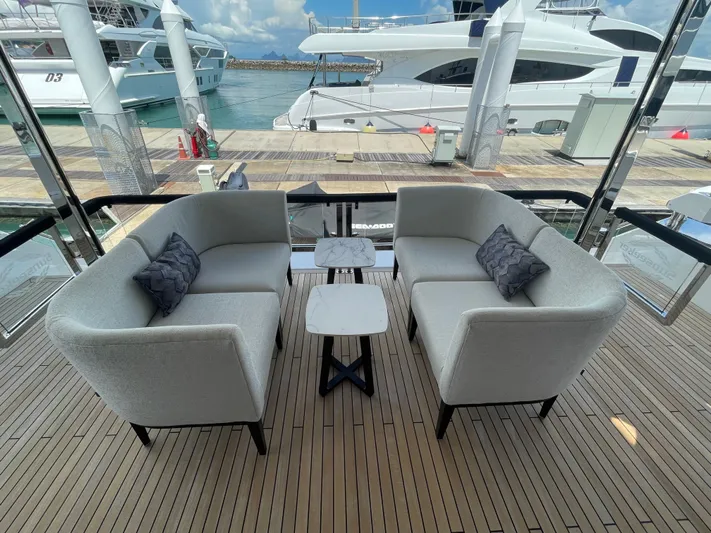  Yacht Photos Pics Luxurious Sunseeker 88 Yacht 2022 with elegant outdoor seating on deck.