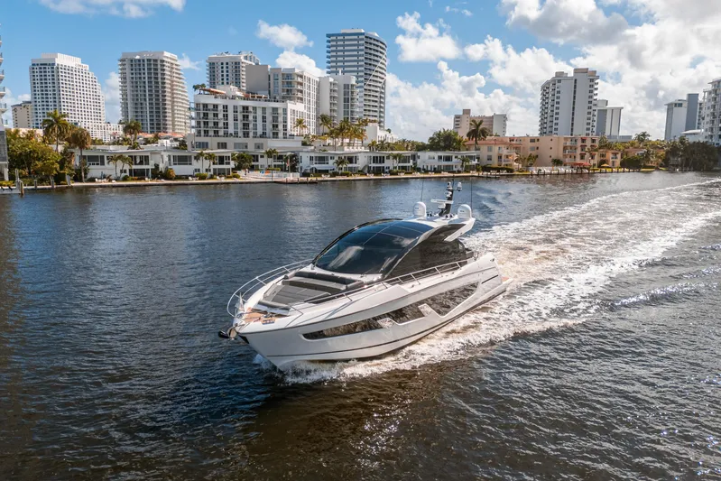 Lorena Yacht Photos Pics Sunseeker Predator 65 yacht cruising near city skyline, 2022 model.