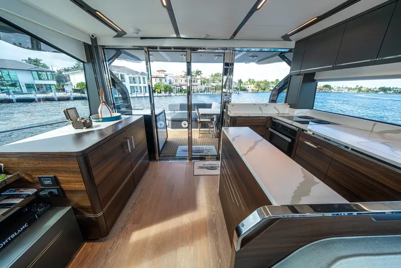 Lorena Yacht Photos Pics Luxurious interior of 2022 Sunseeker Predator 65 yacht with modern kitchen and waterfront view.
