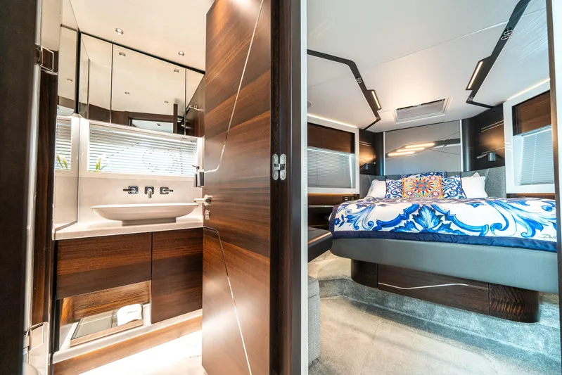 Lorena Yacht Photos Pics Luxurious interior of 2022 Sunseeker Predator 65 yacht with elegant bedroom and bathroom.