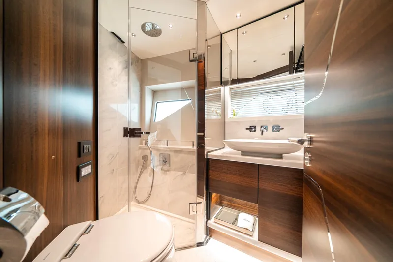 Lorena Yacht Photos Pics Luxurious bathroom in 2022 Sunseeker Predator 65 yacht with modern fixtures and elegant design.