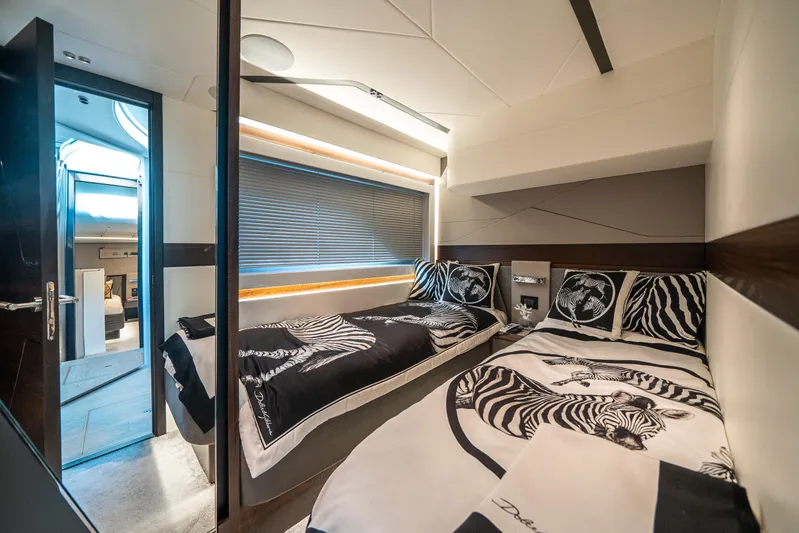 Lorena Yacht Photos Pics Luxurious twin bedroom in 2022 Sunseeker Predator 65 yacht with zebra-themed decor.