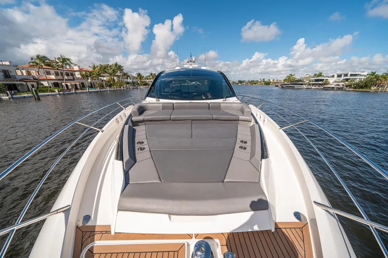 Lorena Yacht Photos Pics Sunseeker Predator 65 yacht, 2022 model, cruising on a sunny day with luxurious deck seating.