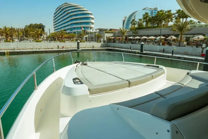  Yacht Photos Pics 2024 Absolute NAVETTA 52 yacht docked in a modern marina with palm trees.