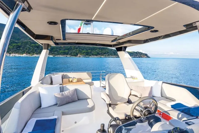  Yacht Photos Pics Luxurious 2024 Absolute NAVETTA 52 yacht interior with ocean view and elegant seating.