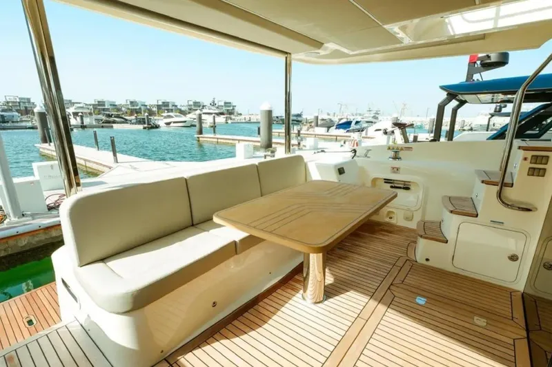  Yacht Photos Pics Luxurious 2024 Absolute NAVETTA 52 yacht interior with elegant seating and wooden table.