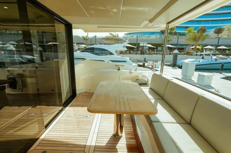 Yacht Photos Pics Luxurious 2024 Absolute NAVETTA 52 yacht interior with elegant seating and wooden table.