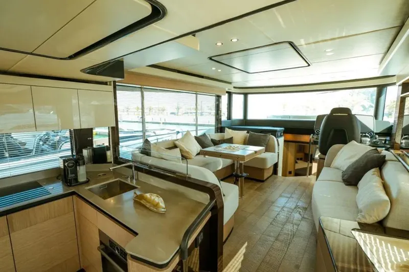  Yacht Photos Pics Luxurious interior of 2024 Absolute NAVETTA 52 yacht with modern kitchen and seating area.