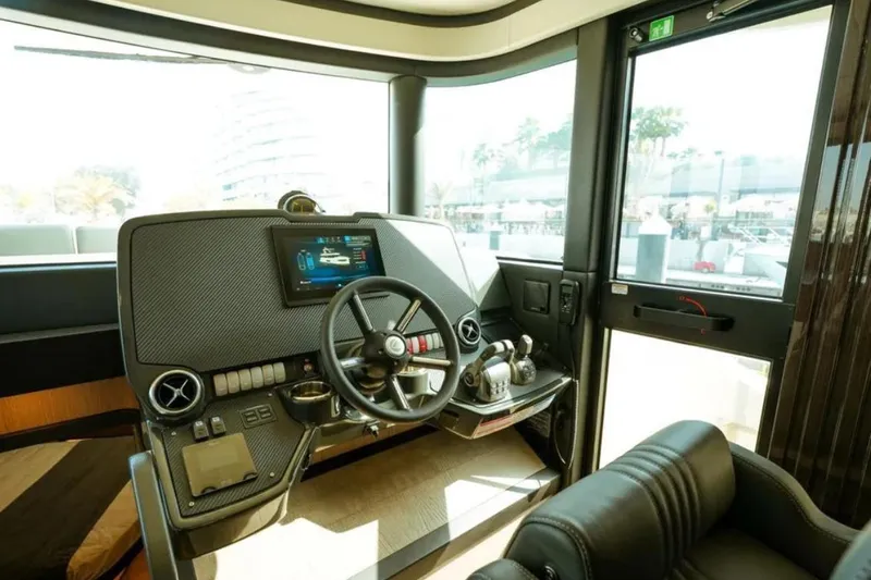  Yacht Photos Pics Helm of 2024 Absolute NAVETTA 52 yacht with modern controls and navigation display.