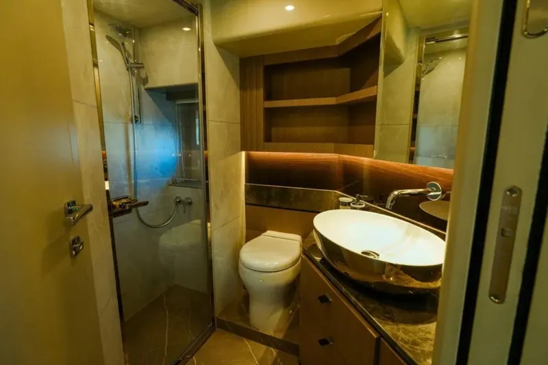  Yacht Photos Pics Luxurious bathroom in 2024 Absolute NAVETTA 52 yacht with modern fixtures and elegant design.