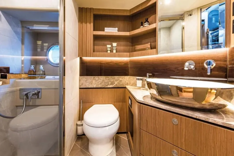  Yacht Photos Pics Luxurious bathroom in 2024 Absolute NAVETTA 52 yacht with modern fixtures and elegant design.