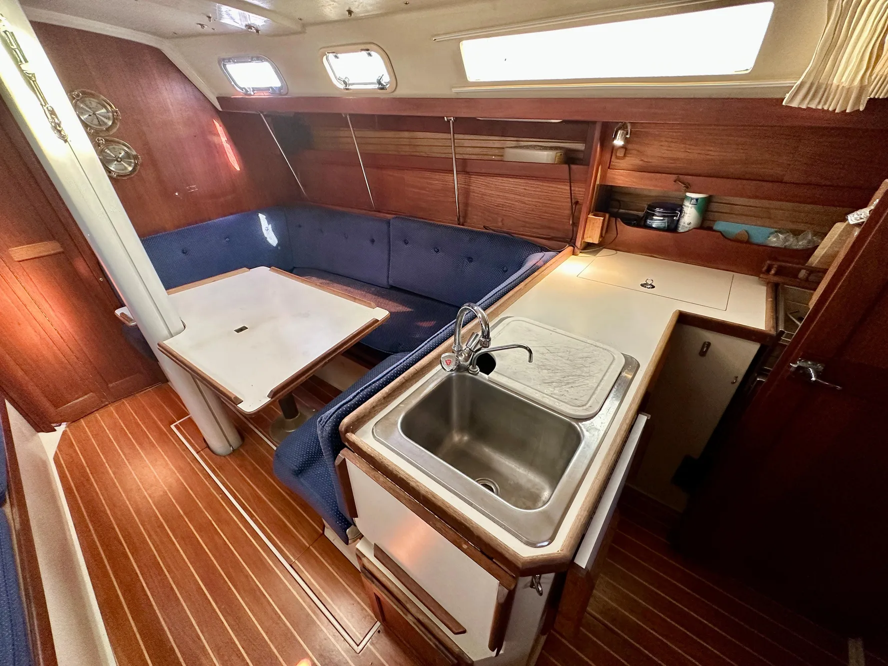 Interior of a 1987 Catalina 34 yacht with kitchen and seating area.