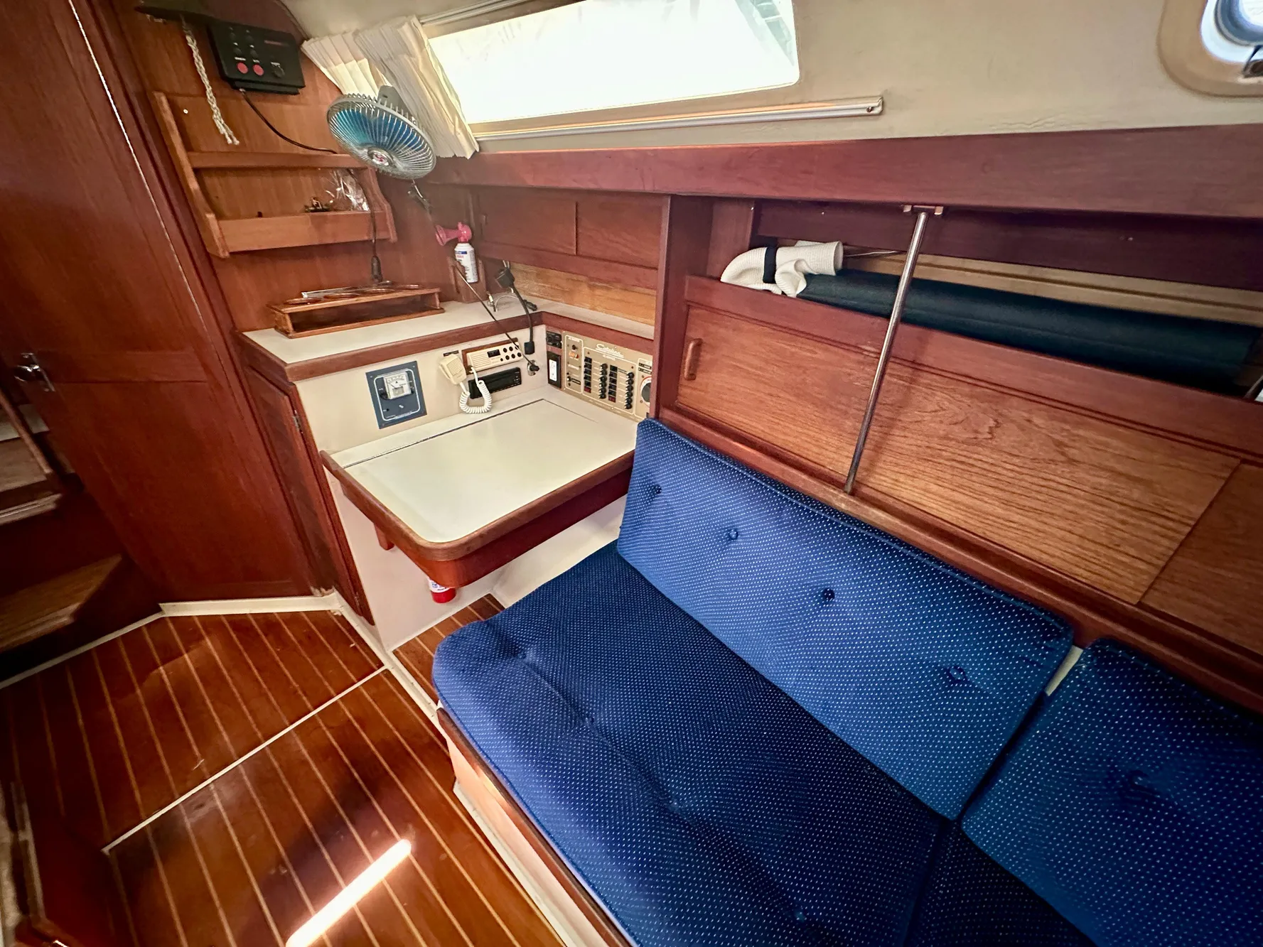 Interior of a 1987 Catalina 34 yacht with blue upholstery.