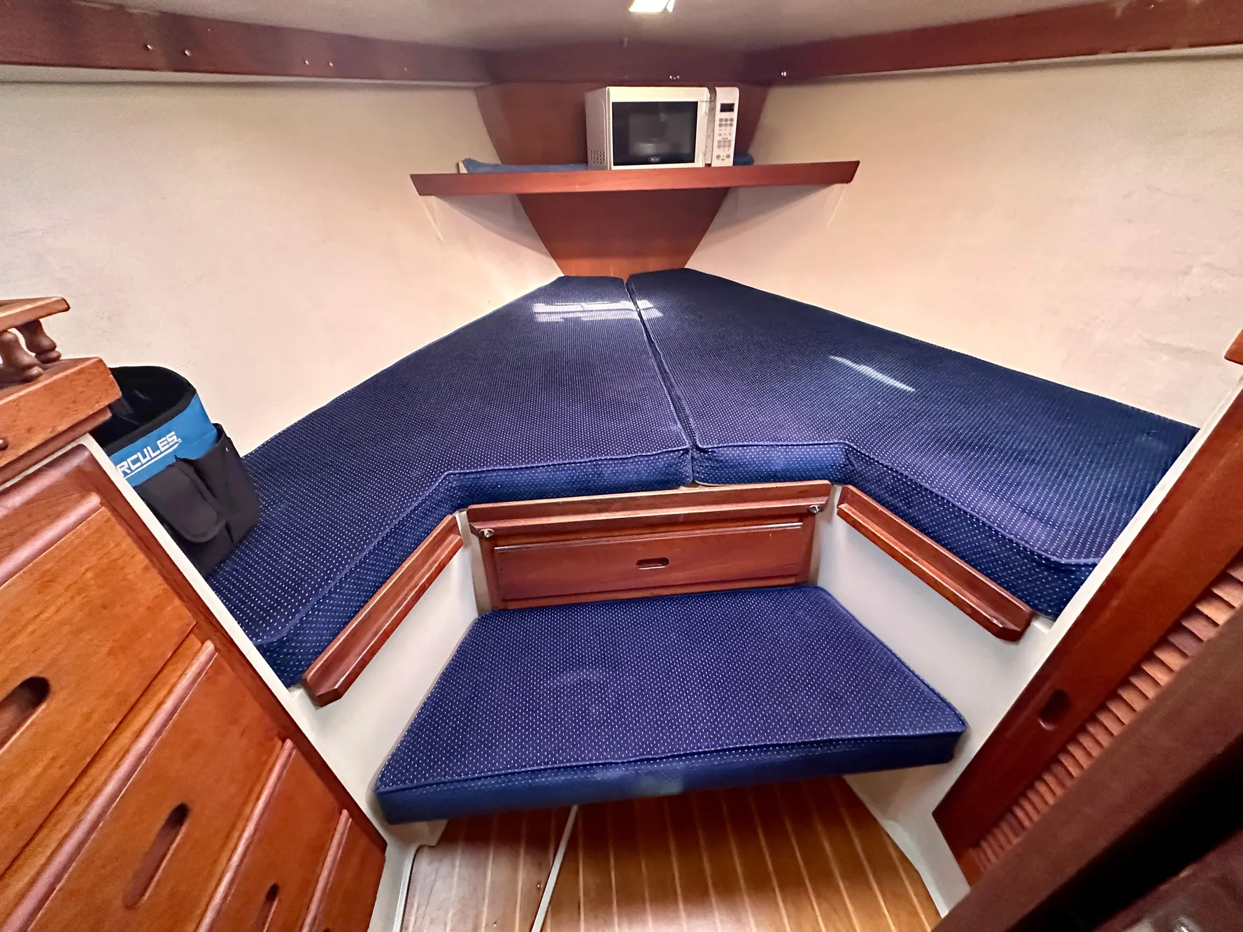Interior of a 1987 Catalina 34 yacht with blue cushions.