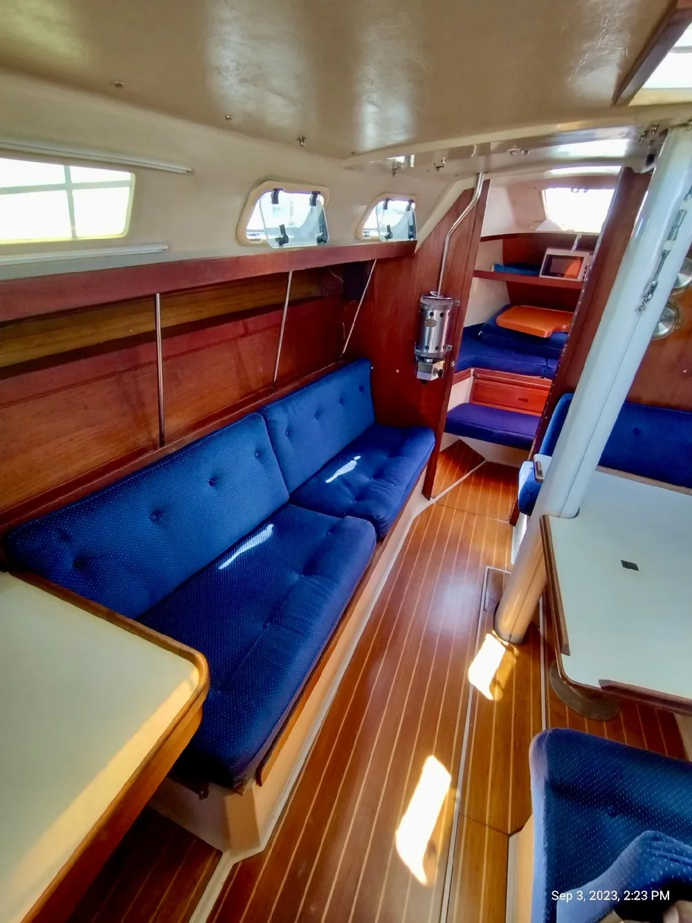Interior of a 1987 Catalina 34 yacht with blue upholstery.