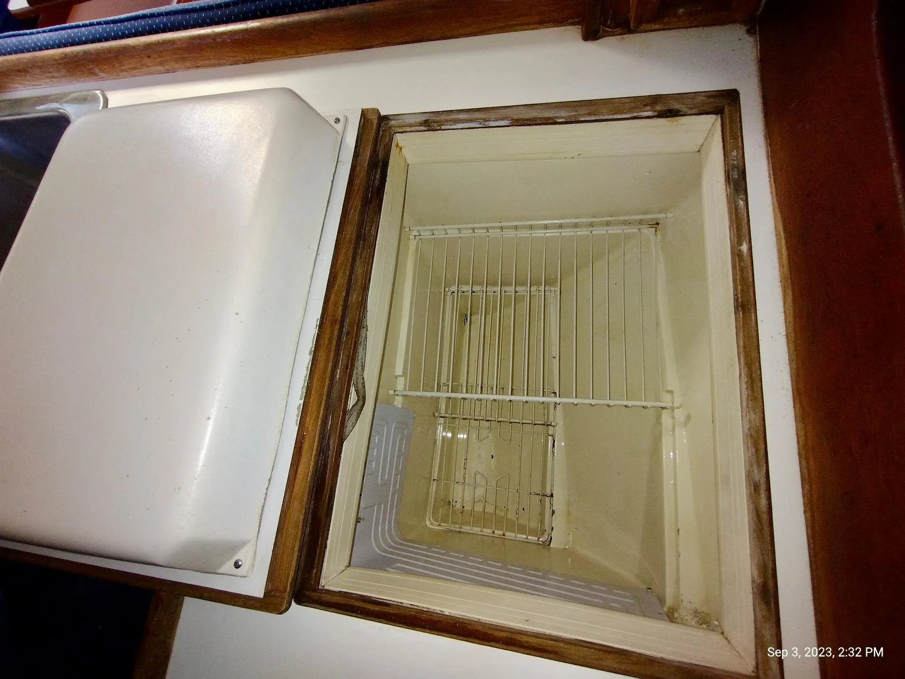 Interior of a 1987 Catalina 34 refrigerator with wire shelf.