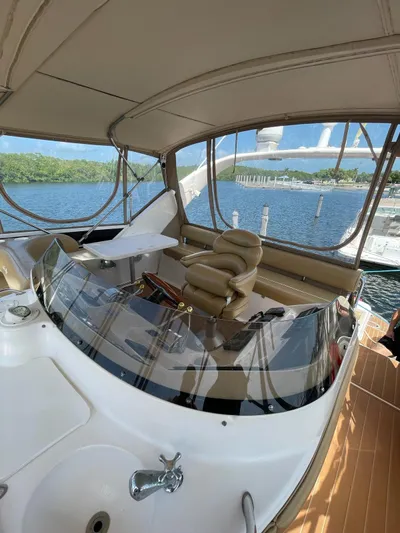 Pal'party Yacht Photos Pics 2000 Sea Ray 450 Express Bridge yacht interior with helm and seating.