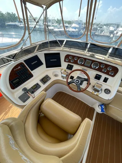 Pal'party Yacht Photos Pics Helm of 2000 Sea Ray 450 Express Bridge with leather seating and advanced navigation controls.