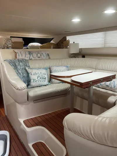 Pal'party Yacht Photos Pics Luxurious interior of 2000 Sea Ray 450 Express Bridge with cozy seating and nautical decor.