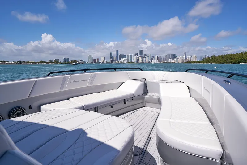 Yacht Photos Pics 2020 Midnight Express 37' Open boat with luxurious seating and city skyline in the background.