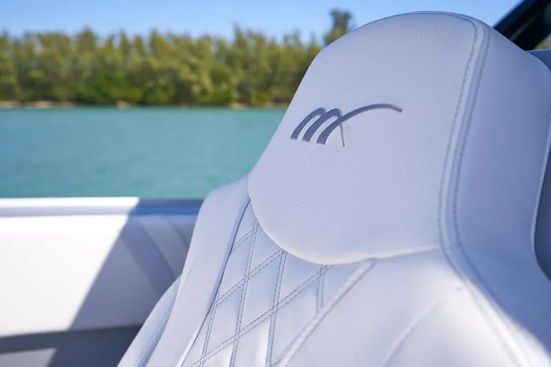  Yacht Photos Pics Close-up of 2020 Midnight Express 37' Open boat's white leather seat with logo.