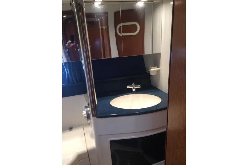  Yacht Photos Pics Bathroom vanity in 1994 Fairline Phantom 37 yacht, featuring a sleek sink and mirror.