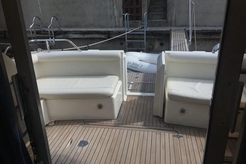  Yacht Photos Pics 1994 Fairline Phantom 37 yacht deck with white seating and wooden flooring.
