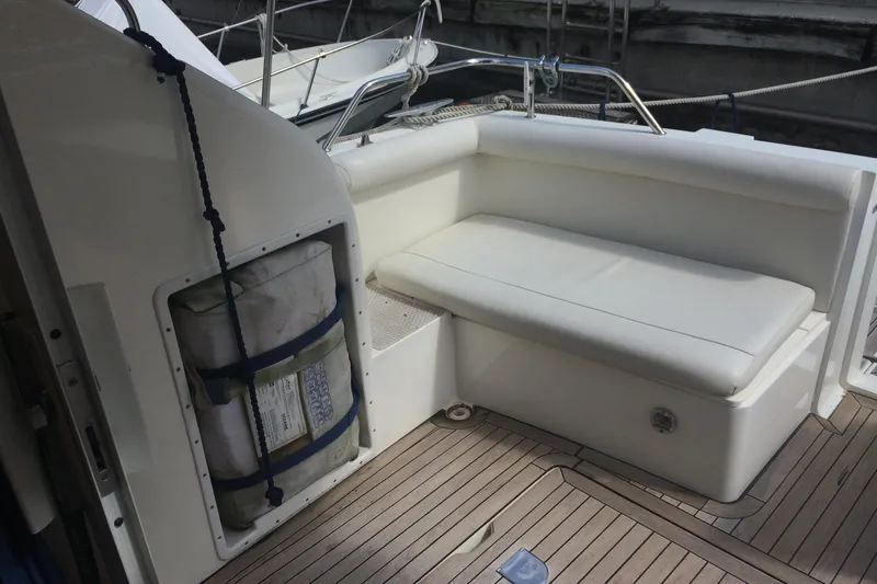  Yacht Photos Pics 1994 Fairline Phantom 37 yacht interior with white seating and wooden deck.