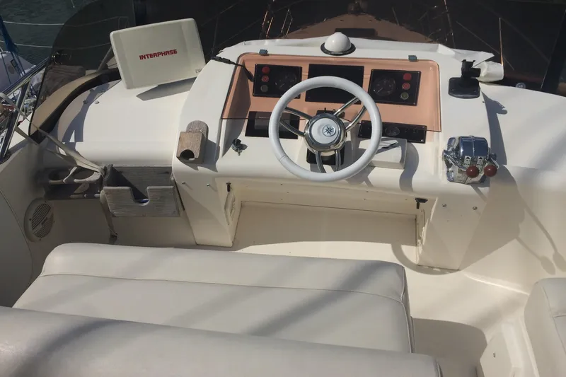  Yacht Photos Pics 1994 Fairline Phantom 37 yacht helm with steering wheel and control panel.