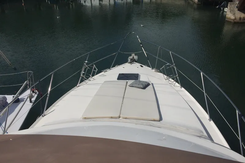  Yacht Photos Pics 1994 Fairline Phantom 37 yacht bow view in a calm marina setting.