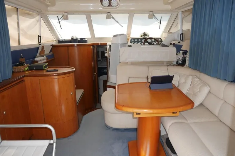  Yacht Photos Pics Interior of 1994 Fairline Phantom 37 yacht with wooden furnishings and cozy seating area.