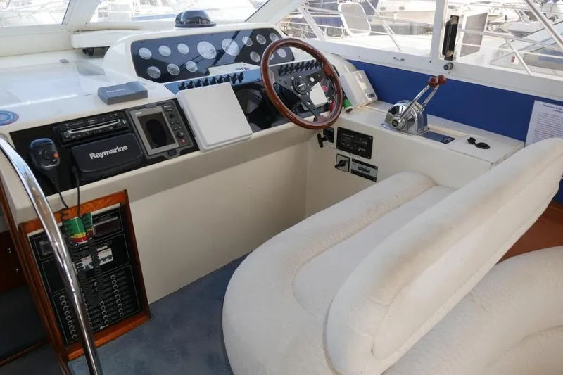  Yacht Photos Pics Cockpit of 1994 Fairline Phantom 37 yacht with steering wheel and navigation equipment.