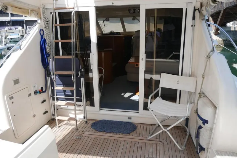  Yacht Photos Pics 1994 Fairline Phantom 37 yacht deck with seating and ladder.