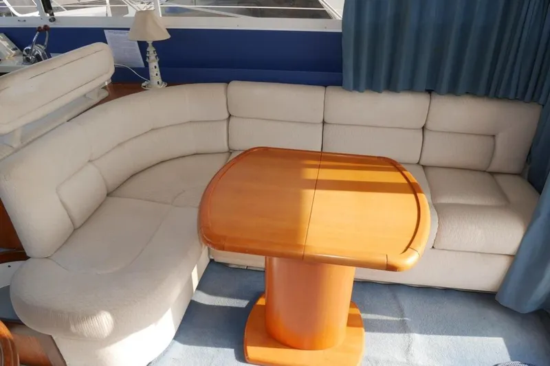  Yacht Photos Pics Luxurious interior of 1994 Fairline Phantom 37 yacht with plush seating and wooden table.